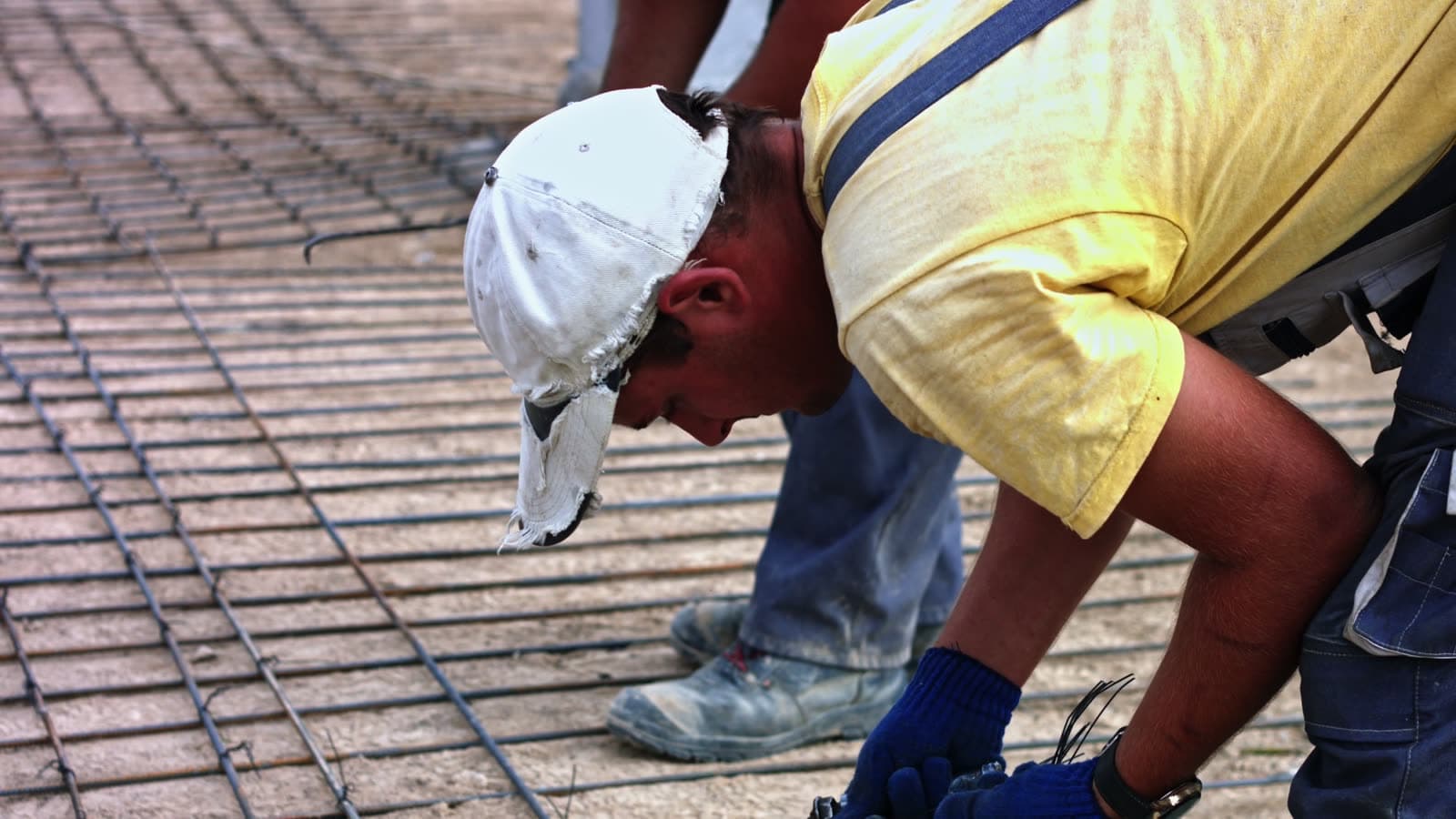 Construction workers installing reinforcing steel