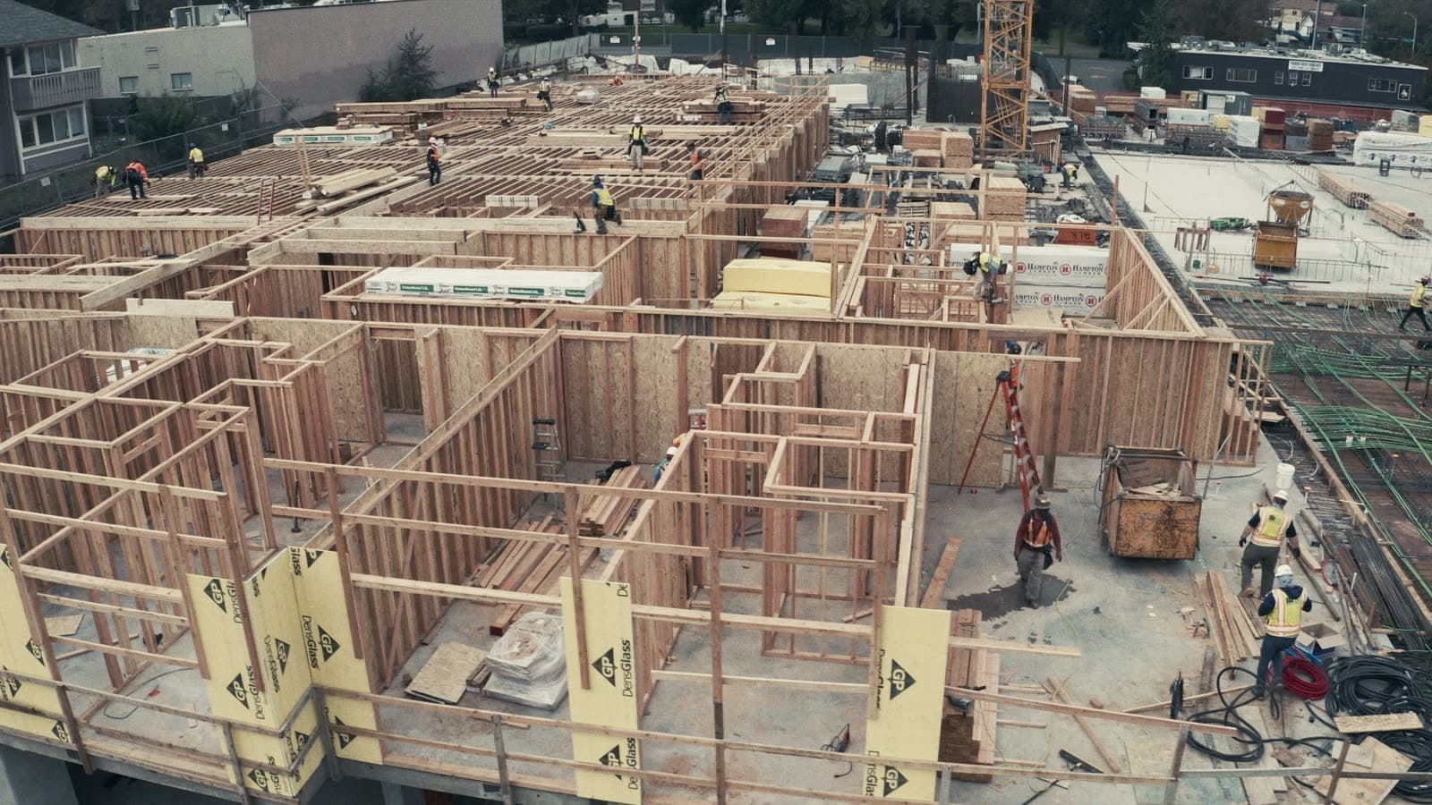 Active construction project with crews framing a building